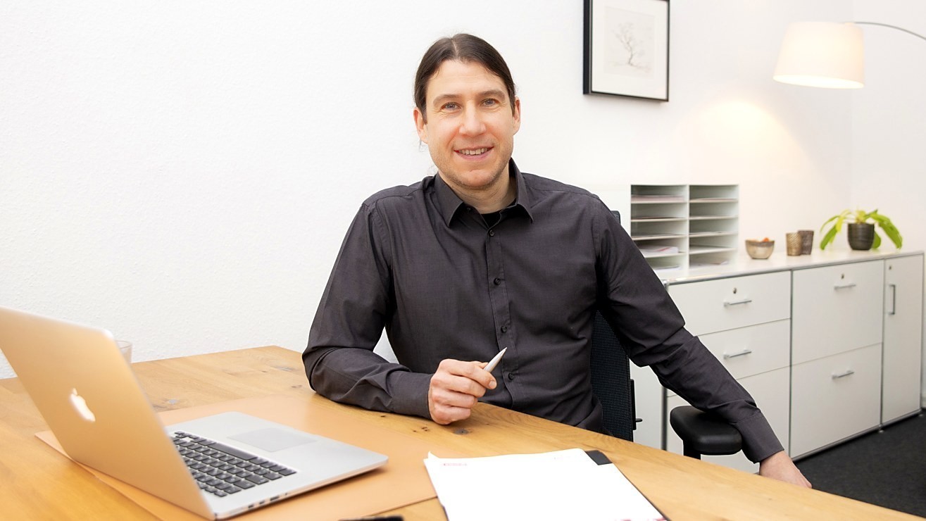 Dr Johannes Harbort, psychologist and licensed psychotherapist, at his desk in Wiesbaden